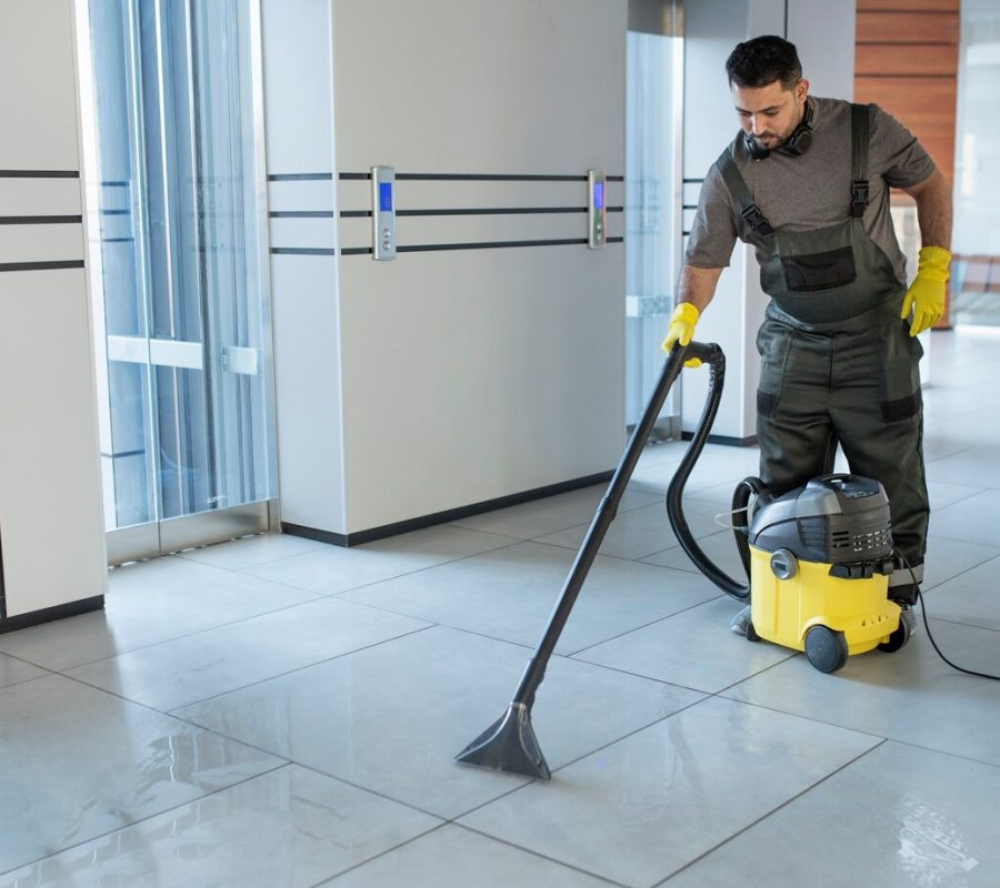 full-shot-man-vacuuming-office-floor_23-2149345550